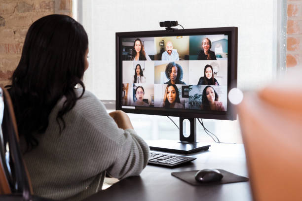 A business woman participates in a virtual staff meeting facilitated by an efficient Cisco Collaboration system